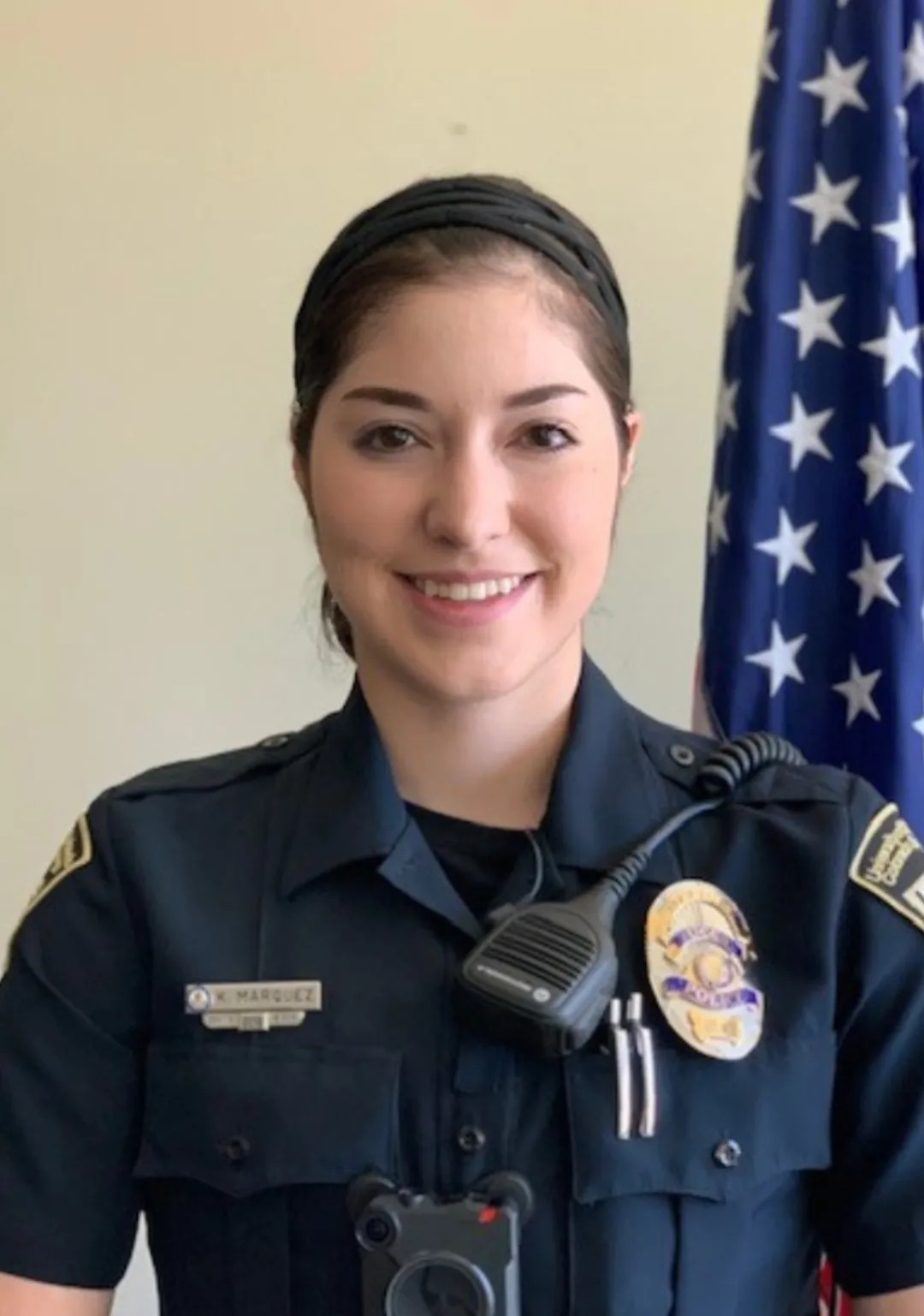 Corporal Marquez in front of flag